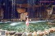 A woman in a pink bikini standing in a pool of water.