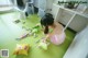 A woman sitting on the floor in front of a pile of candy.